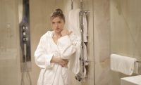 women in bathrobe outside shower