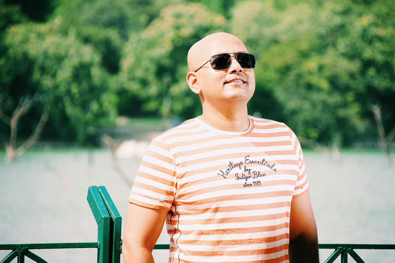 bald man wearing sunglasses and smiling