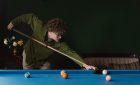 man playing pool billiards
